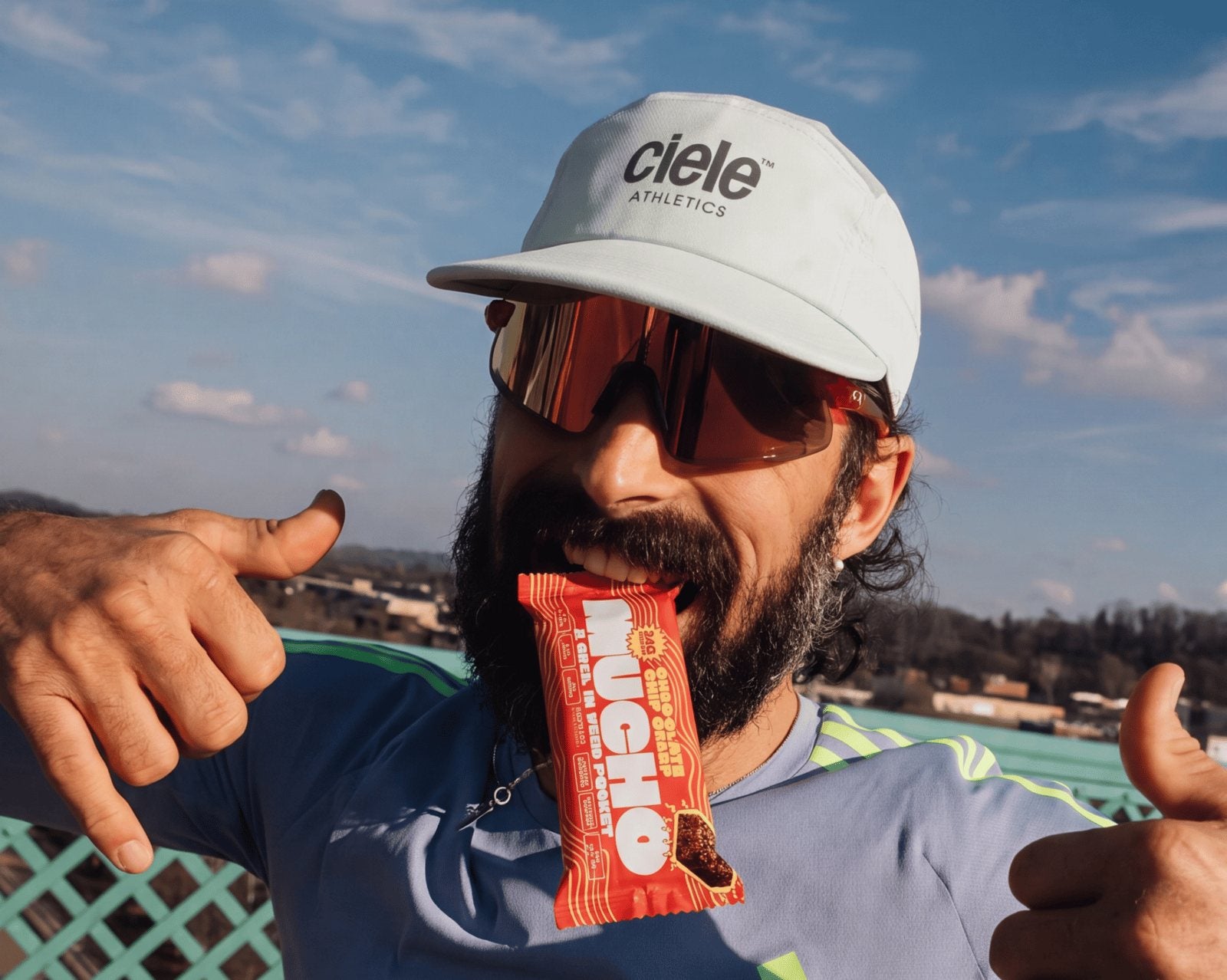 Cyclist eating a Mucho protein bar mid-ride
